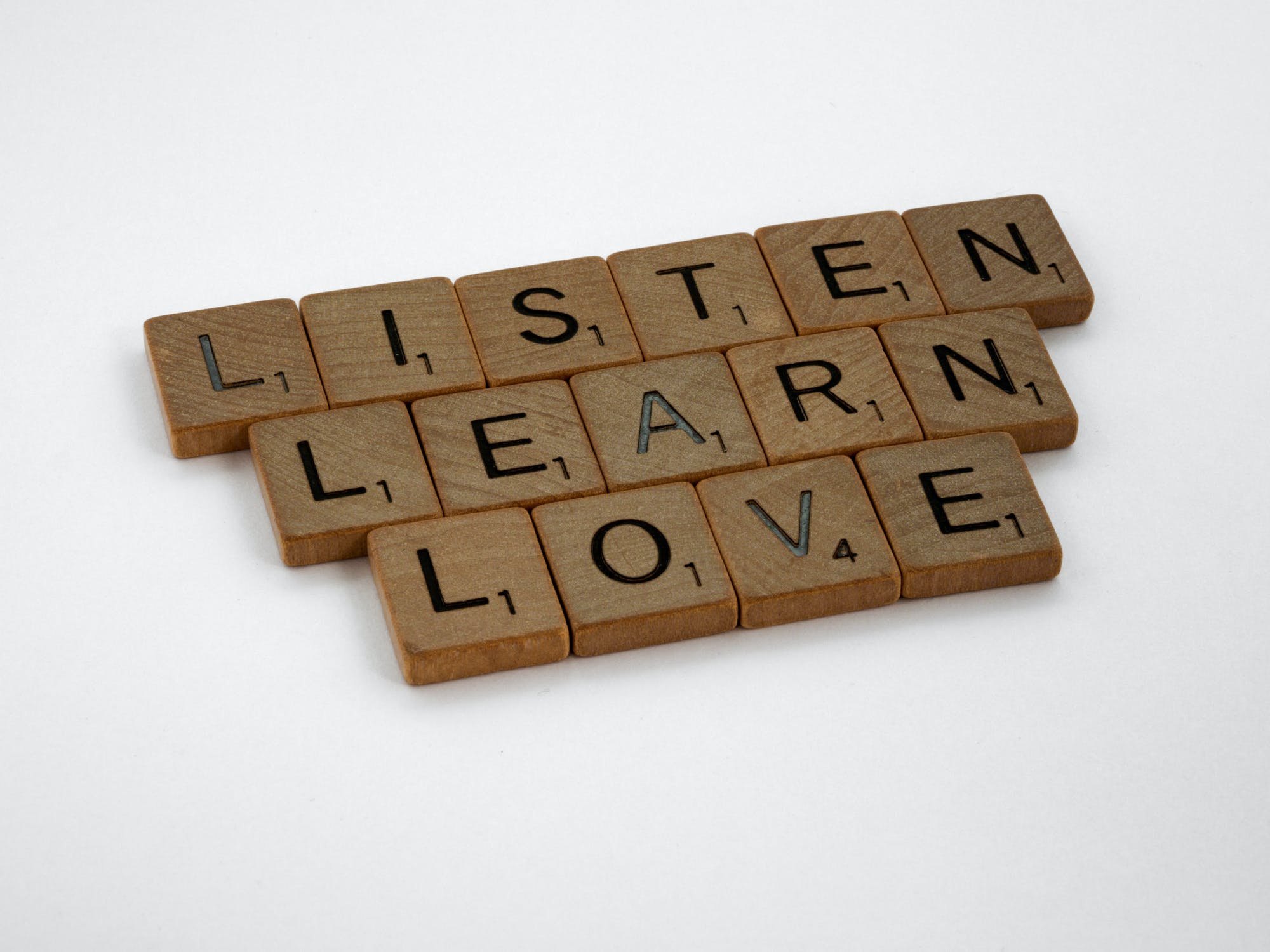 Tiles making up the words listen, learn, love